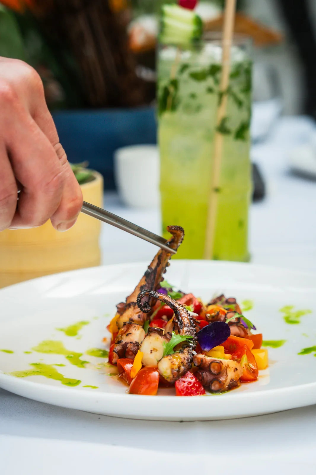 Grilled octopus with heirloom tomato, strawberry, edible flowers and basil oil